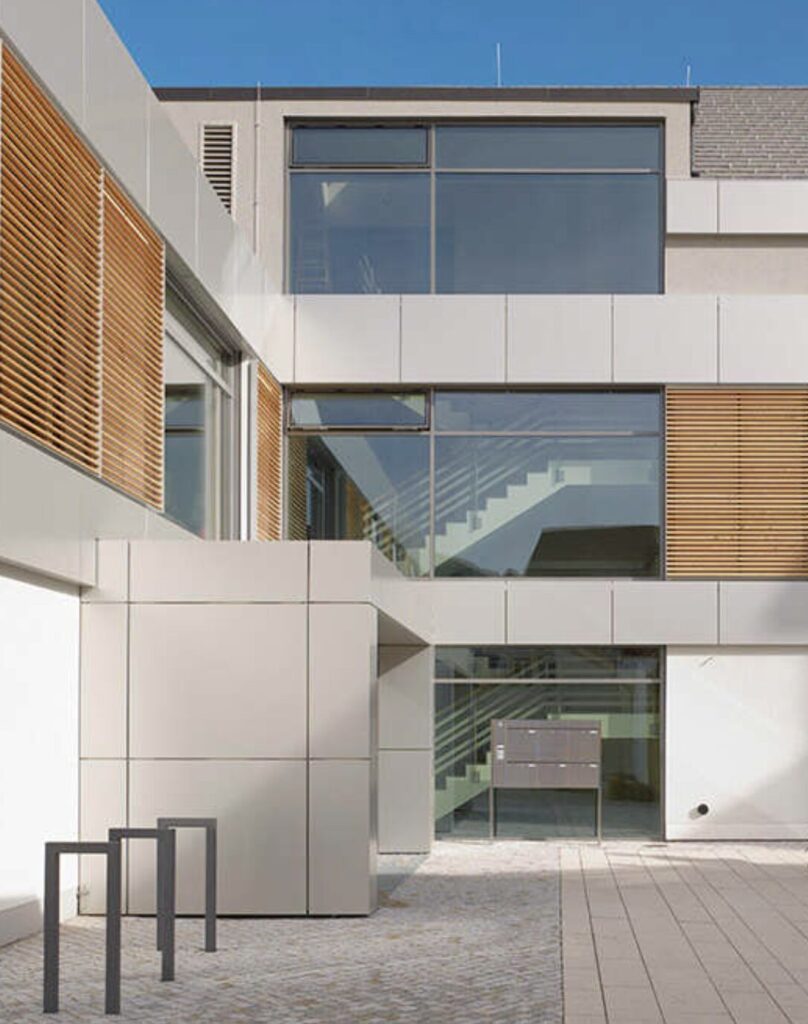 Moderne Fassade eines IMBRO-Gebäudes mit Holzelementen
