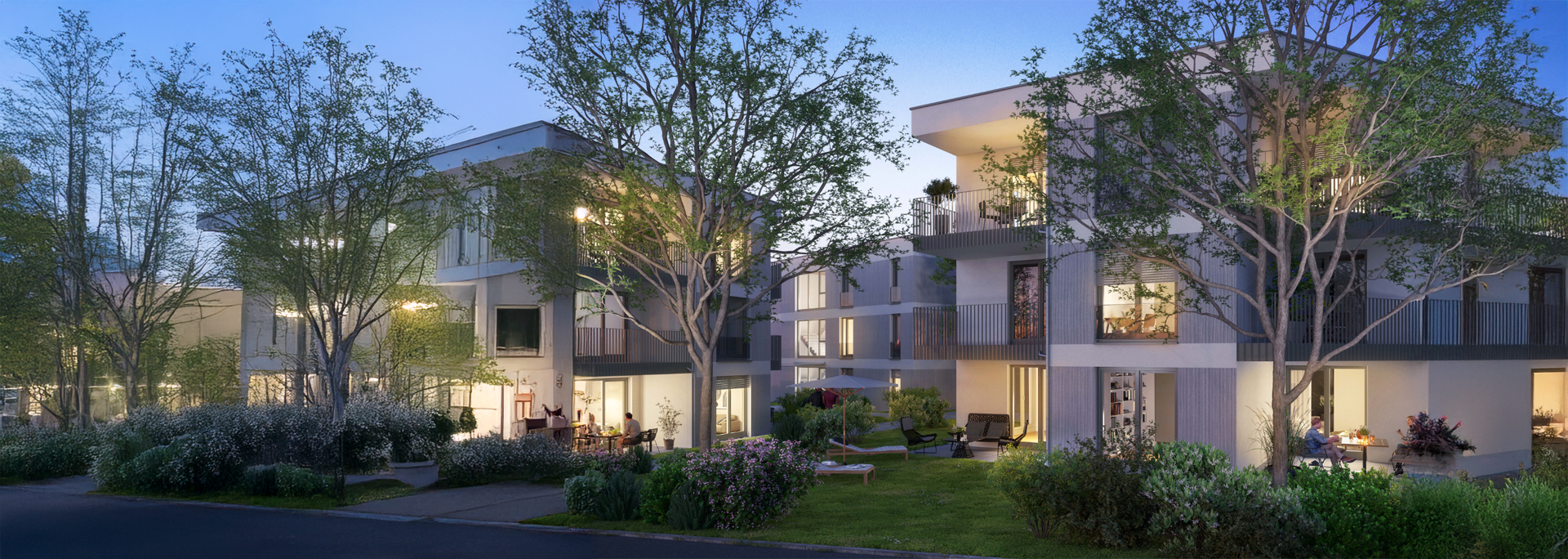 Moderne Wohnanlage im Schwarzwald in der Abenddämmerung – realisiert von IMBRO Immobilien