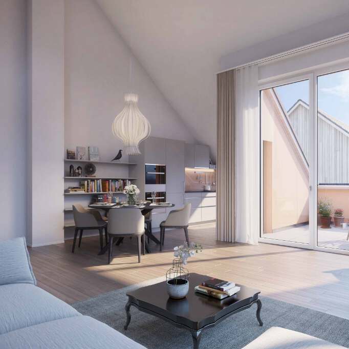 Lichtdurchfluteter Essbereich einer modernen Dachgeschosswohnung mit Zugang zur Terrasse