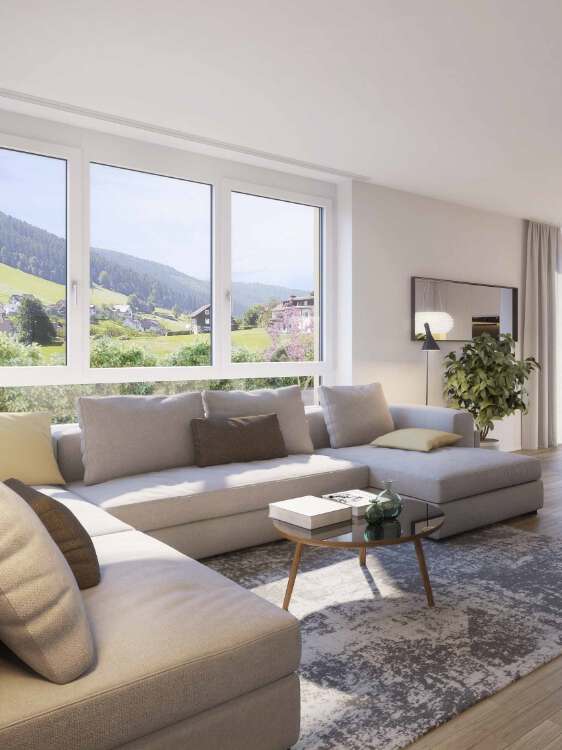 Helles, modernes Wohnzimmer mit großem Ecksofa und Panoramafenster mit Blick auf den Schwarzwald